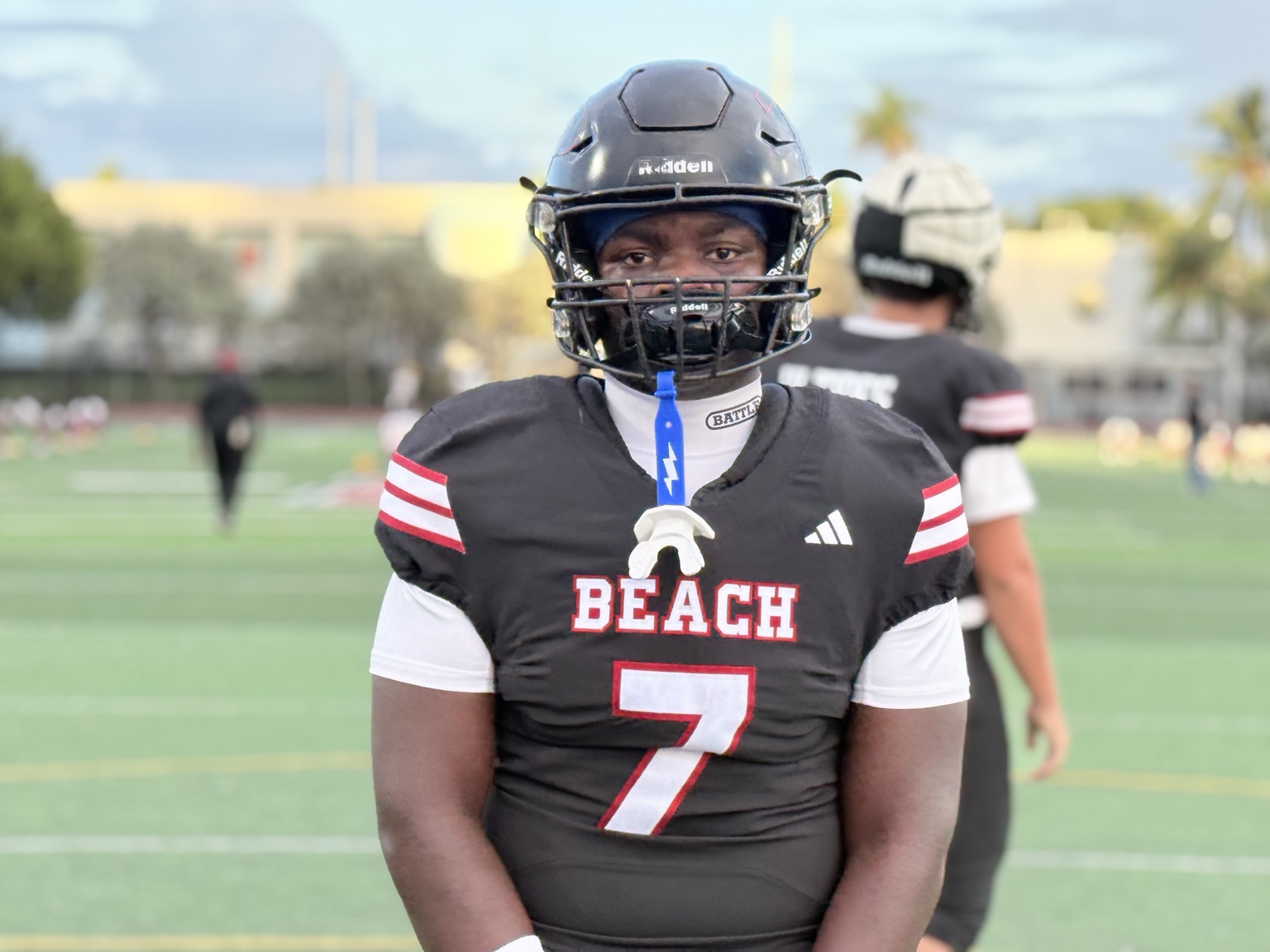 Football player wearing a black Beach number 7 jersey and black helmet on the field