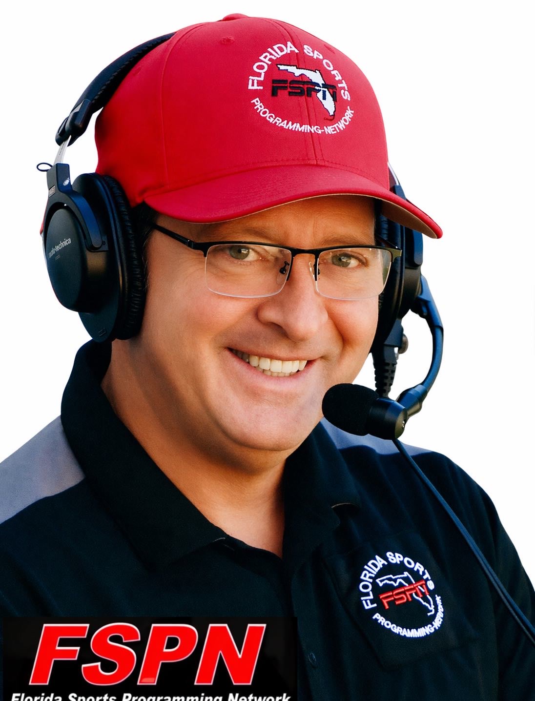 Brian Uncle Mugs Gonzalez in his red FSPN cap with a broadcast headset and microphone